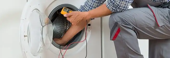 Dryer repair technician inspecting and repairing a clothes dryer in Staten Island, NY