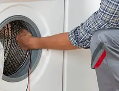 Dryer repair technician diagnosing and servicing a clothes dryer in Staten Island, NY