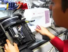 Vacuum repair technician servicing internal components on a workbench in Staten Island, NY