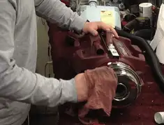 Vacuum repair technician cleaning and servicing a vacuum motor in Staten Island, NY