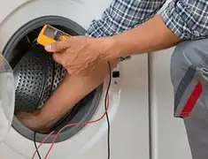 Washing machine repair technician testing a front-load washer with diagnostic tools in Staten Island, NY